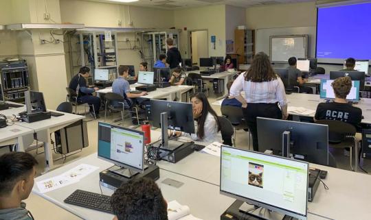 Picture of high school students building a robotic car during a summer camp program